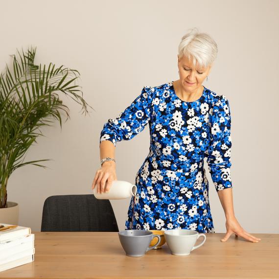 Blue dress pouring cacao looking down