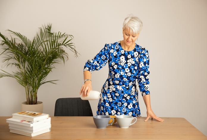 Blue dress pouring cacao looking down